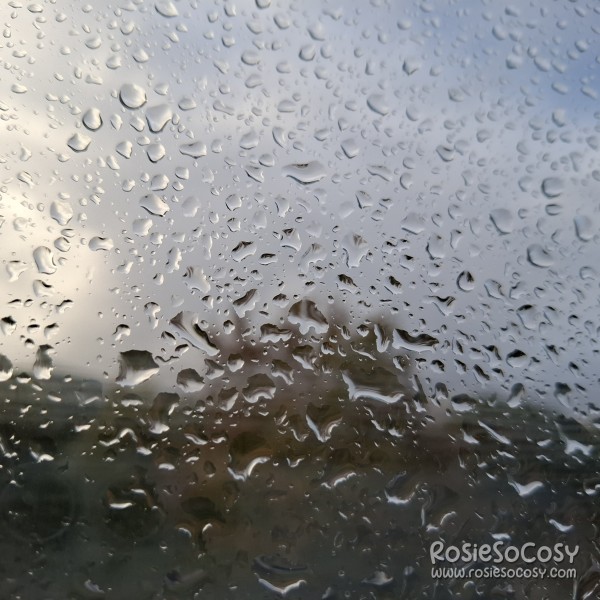 A photograph of a window with water droplets on it.