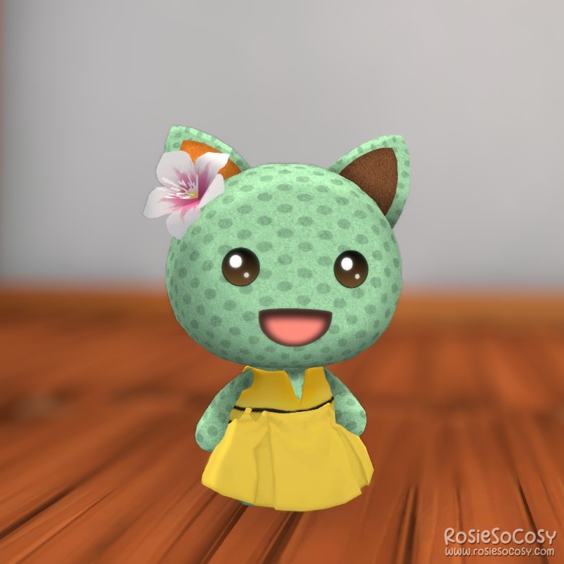 Rosie's character in Garden Paws is a minty green cat, with a dotted pattern all over, and an orange and brown ear. She is wearing a pink flower on her head, a yellow skirt and a yellow life jacket. The yellow items together look like a cute dress.